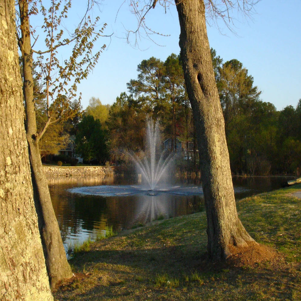 View from a pond bank of fountain in pond using the Bearon Aquatics Artemis Nozzle | Your Pond Pros 