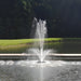 Fountain operating in pond next to small dock using the Bearon Aquatics Aurora Nozzle | Your Pond Pros